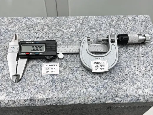 Digital caliper and micrometer on a granite plate